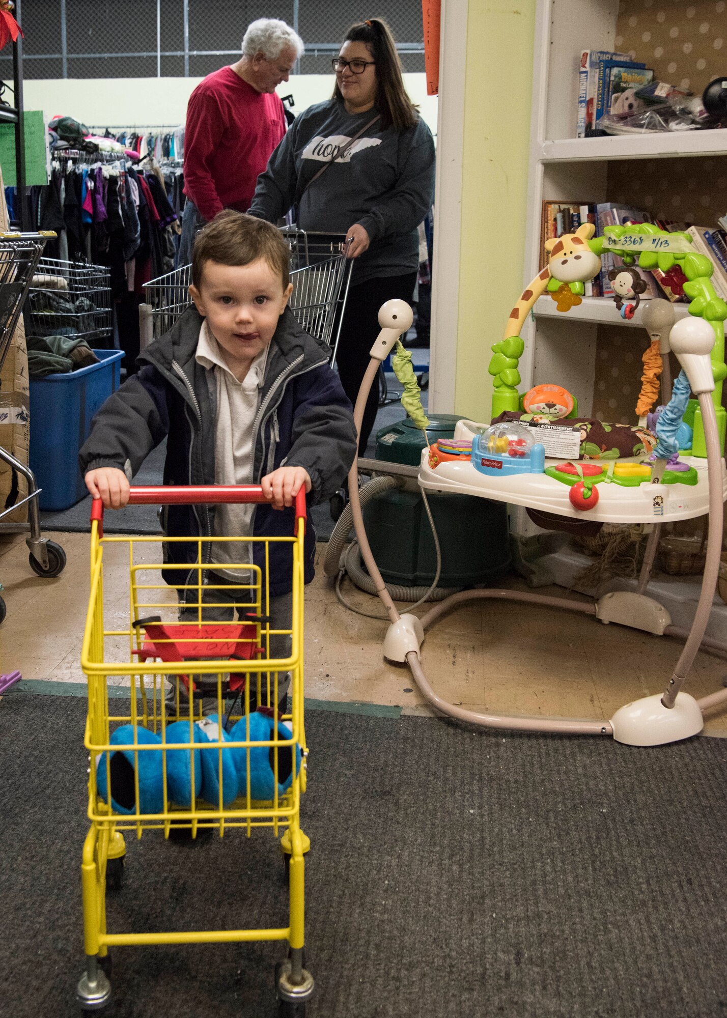 Lachland, age 2, son of U.S. Air Force Senior Airman Jacob Johnson, a 301st Intelligence Squadron fusion analyst, shops with his mother Tiffani, at the Fort Richardson Thrift Shop, Joint Base Elmendorf-Richardson, Alaska Dec. 12, 2018. The store is open to all branches of active duty, the National Guard, Reserve, retired military personnel, their dependents and anyone with access to JBER.