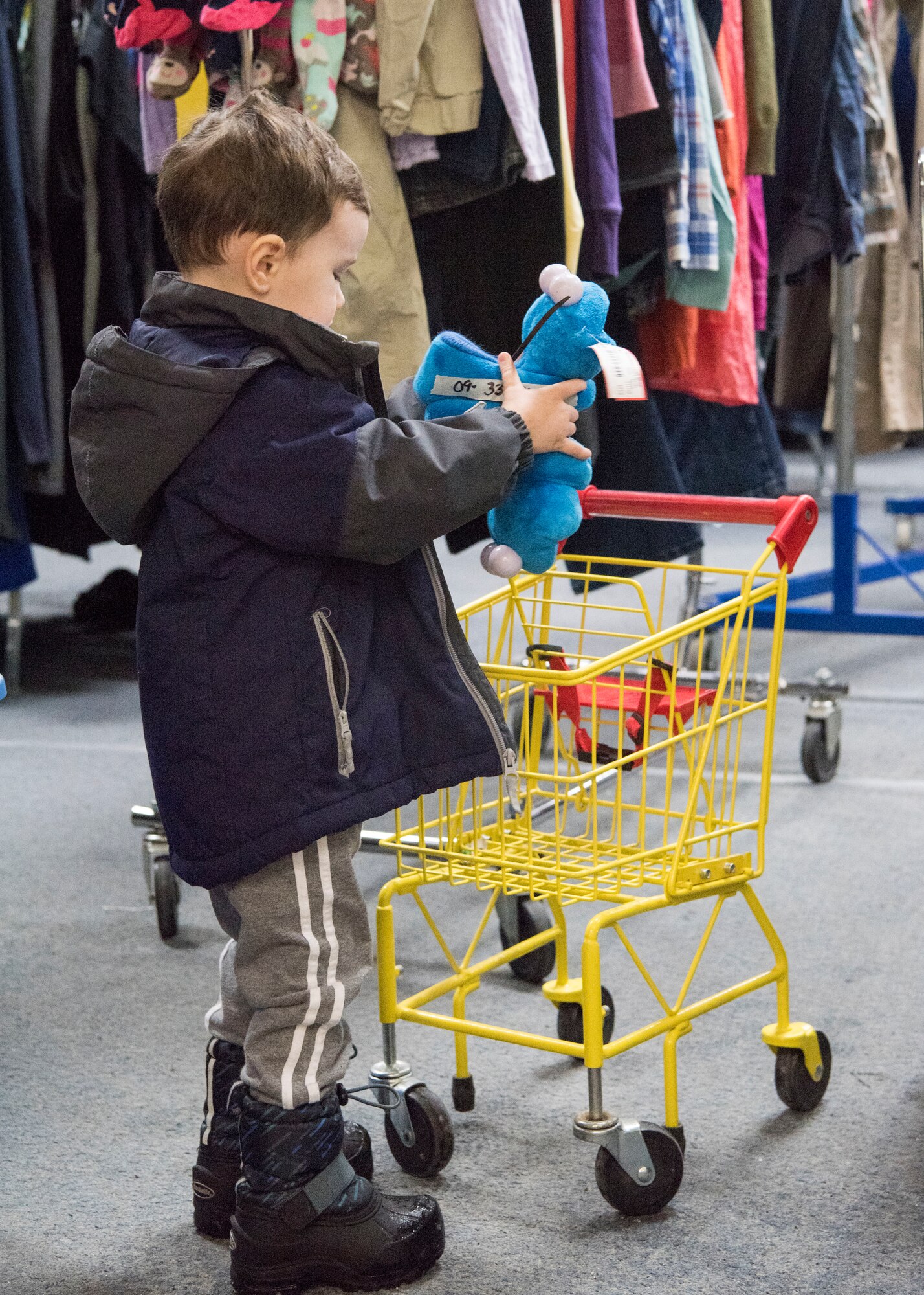 Lachland, age 2, son of U.S. Air Force Senior Airman Jacob Johnson, a 301st Intelligence Squadron fusion analyst, shops with his mother Tiffani, at the Fort Richardson Thrift Shop, Joint Base Elmendorf-Richardson, Alaska Dec. 12, 2018. The store is open to all branches of active duty, the National Guard, Reserve, retired military personnel, their dependents and anyone with access to JBER.