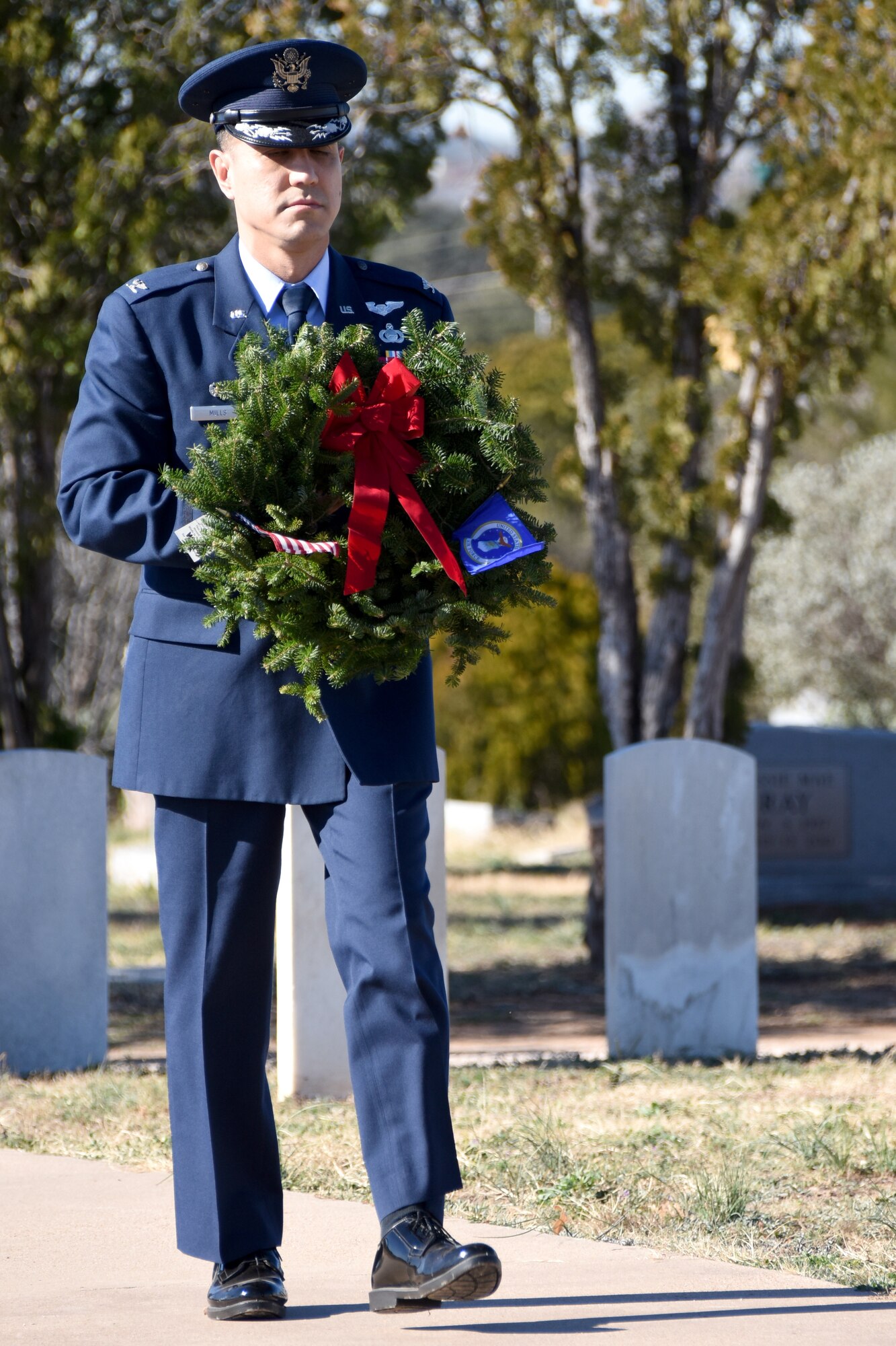 U.S. Air Force Col. Ricky Mills, 17th Training Wing commander, shows honor and respect for veterans and active duty members serving in the Air Force with a wreath symbolizing that branch of the armed forces during the Wreaths Across America ceremony at Belvedere Memorial Cemetery, San Angelo, Texas, Dec. 15, 2018. Other leaders from Goodfellow each laid a wreath representing all veterans and duty members from the different branches. (U.S. Air Force photo by Airman 1st Class Seraiah Hines/ Released)