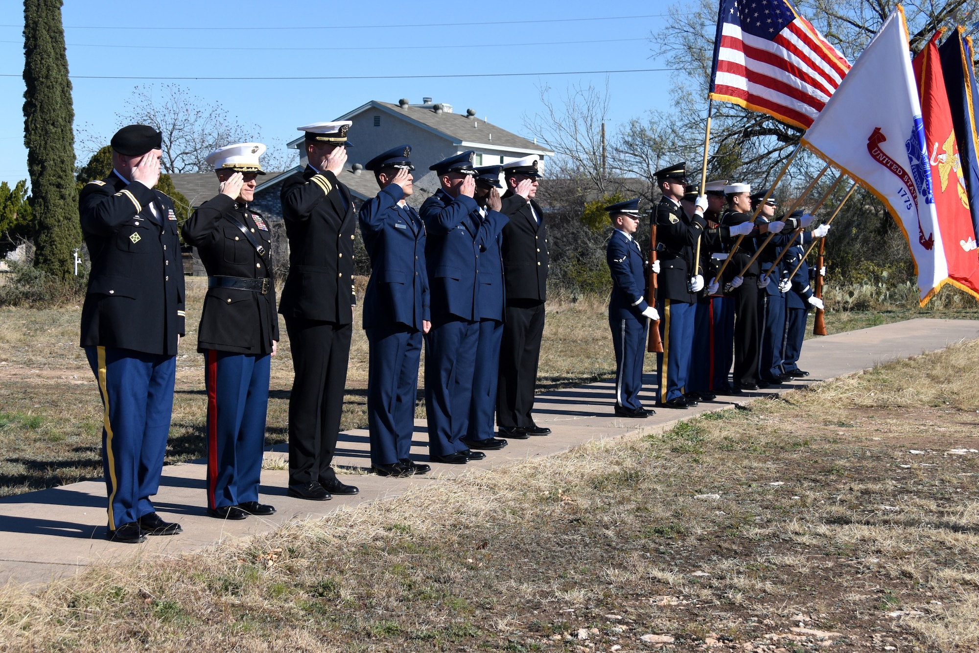 Leaders from Goodfellow salute as the Goodfellow Joint Service Color Guard retires the colors and taps is played, honoring veterans who gave the ultimate sacrifice for freedom at the Wreaths Across America ceremony held in the Belvedere Cemetery, San Angelo, Texas, Dec. 15, 2018. After the ceremony members from the base and community laid wreaths on the gravestones of veterans as a way to honor them and their sacrifice. (U.S. Air Force photo by Airman 1st Class Seraiah Hines/ Released)