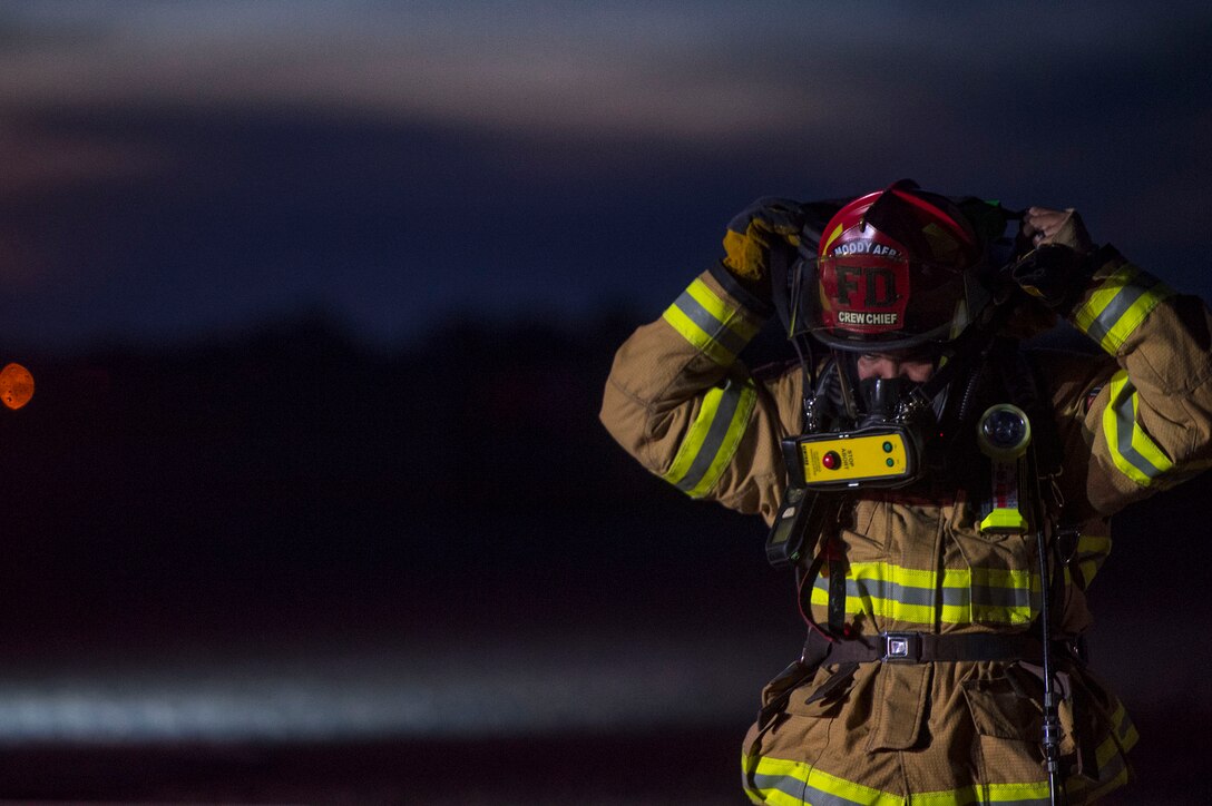 A 23d Civil Engineer Squadron firefighter prepares to respond to a simulated aircraft ground emergency during live-fire training, Nov. 29, 2018, at Moody Air Force Base, Ga. The units strengthened their alliance and firefighting capabilities by jointly extinguishing a simulated aircraft fire to maintain their Airport Rescue and Firefighting proficiency. (U.S. Air Force photo by Senior Airman Greg Nash)