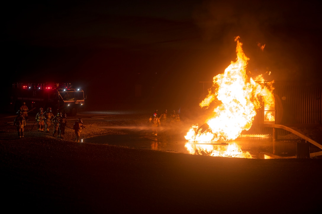 Firefighters from the 23d Civil Engineer Squadron and Valdosta Fire Department conduct live-fire training, Nov. 29, 2018, at Moody Air Force Base, Ga. The units strengthened their alliance and firefighting capabilities by jointly extinguishing a simulated aircraft fire to maintain their Airport Rescue and Firefighting proficiency. (U.S. Air Force photo by Senior Airman Greg Nash)