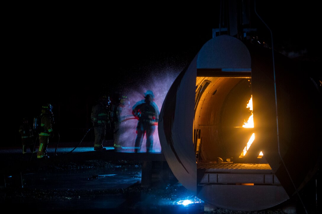 Firefighters from the 23d Civil Engineer Squadron and Valdosta Fire Department respond to a simulated aircraft ground emergency during live-fire training, Nov. 29, 2018, at Moody Air Force Base, Ga. The units strengthened their alliance and firefighting capabilities by jointly extinguishing a simulated aircraft fire to maintain their Airport Rescue and Firefighting proficiency. (U.S. Air Force photo by Senior Airman Greg Nash)