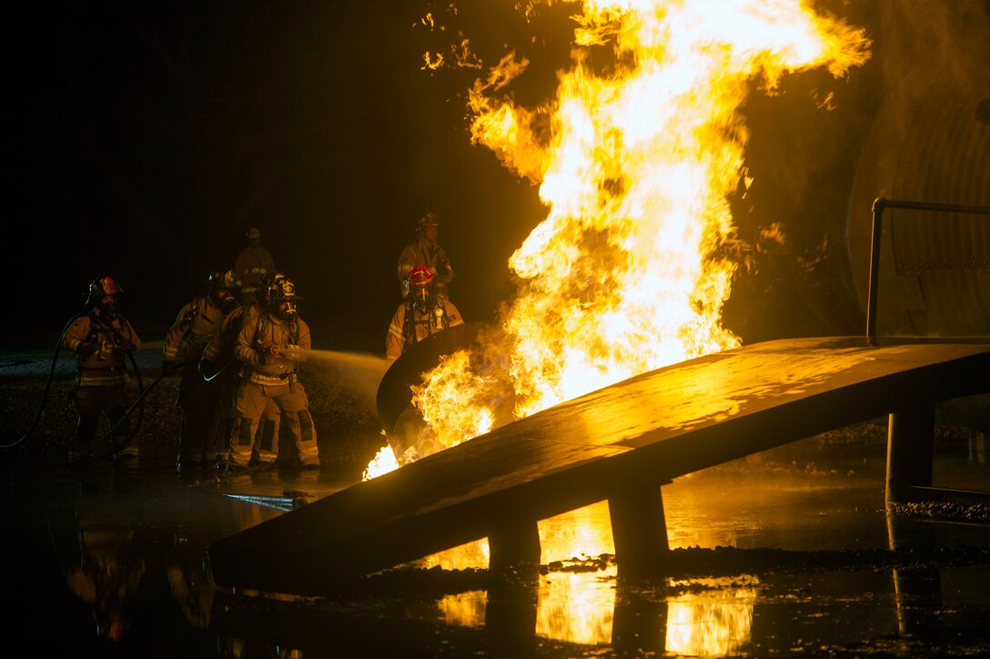 Firefighters from the 23d Civil Engineer Squadron and Valdosta Fire Department conduct live-fire training, Nov. 29, 2018, at Moody Air Force Base, Ga. The units strengthened their alliance and firefighting capabilities by jointly extinguishing a simulated aircraft fire to maintain their Airport Rescue and Firefighting proficiency. (U.S. Air Force photo by Senior Airman Greg Nash)