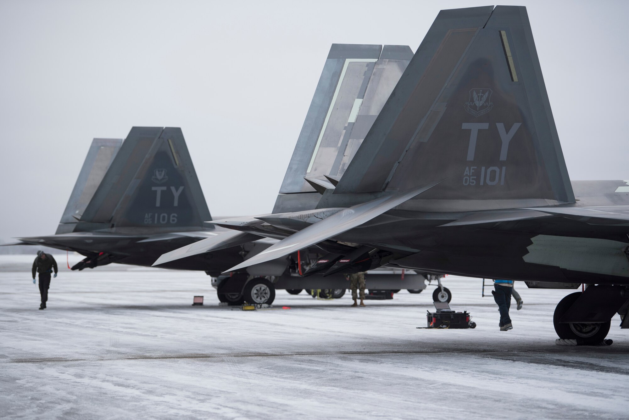 U.S. Air Force F-22 Raptors assigned to the 95th Fighter Squadron from Tyndall Air Force Base, Florida, sit on the flightline after landing at Joint Base Elmendorf-Richardson, Alaska, Dec. 17, 2018.