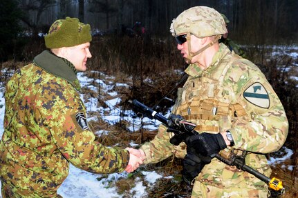 U.S. Army 1st Lt. Ethan Milukas, a platoon leader with 2nd Battalion, 12th Cavalry Regiment, 1st Armored Brigade Combat Team, 1st Cavalry Division greets an Estonian military leader at Christmas Thunder, a training exercise with Estonian Soldiers held near Ahja, Estonia, Dec. 11, 2018.  The Soldiers are in Estonia in support of the 1st ABCT Atlantic Resolve rotation across Europe, which is to improve the interoperability between U.S. forces and their NATO allies and partners.