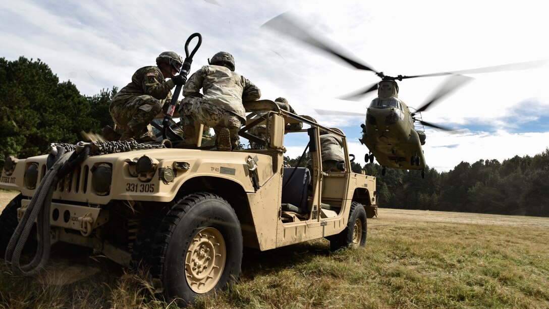 U.S. Army Soldiers from the 11th Transportation Battalion, 7th Transportation Brigade (Expeditionary), conduct sling load operations during a training exercise at Joint Base Langley-Eustis, Virginia, Oct. 17, 2018. The training will conclude with a two-week field training exercise to prepare Soldiers within the battalion for future deployments. (U.S. Army photo by Spc. Travis Teate)