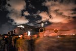 Soldiers passing in the night before a dimly lit C17 from the 172nd Air Wing of the Mississippi National Guard, are arriving for a training exercise in the Virgin Islands to provide support to civil authorities in a post hurricane training scenario.