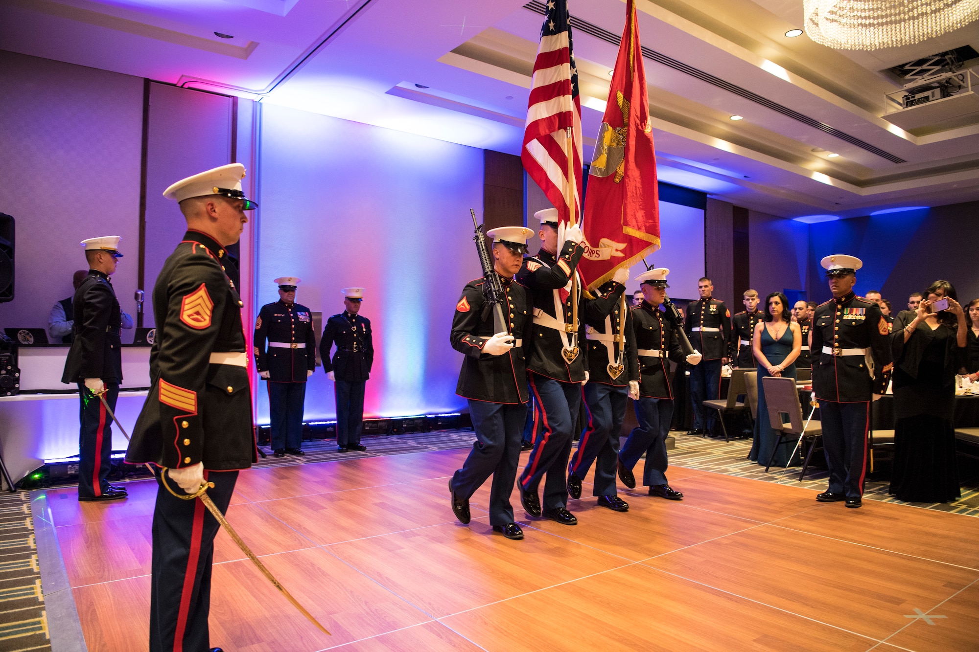 Members of the Marine Corps Color Guard carry the colors during the opening ceremonies of the Marine Corps Ball in Indianapolis, Ind., Nov. 17, 2018. Members of Detachment 1, Communications Company, Headquarters and Service Battalion, 4th Marine Logistics Group gathered to celebrate the 243rd birthday of the Marine Corps. (U.S. Air Force photo / Senior Airman Harrison Withrow)