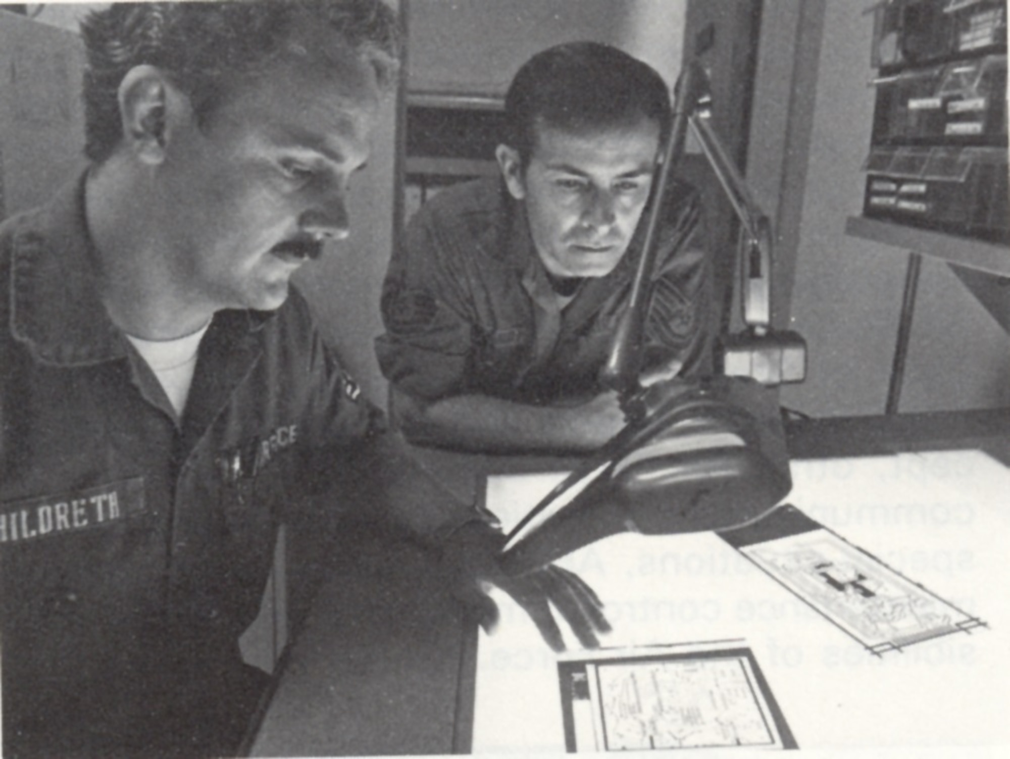 Members of the 1842nd Electronics Engineering Group review circuit board negatives, Scott AFB, Illinois.