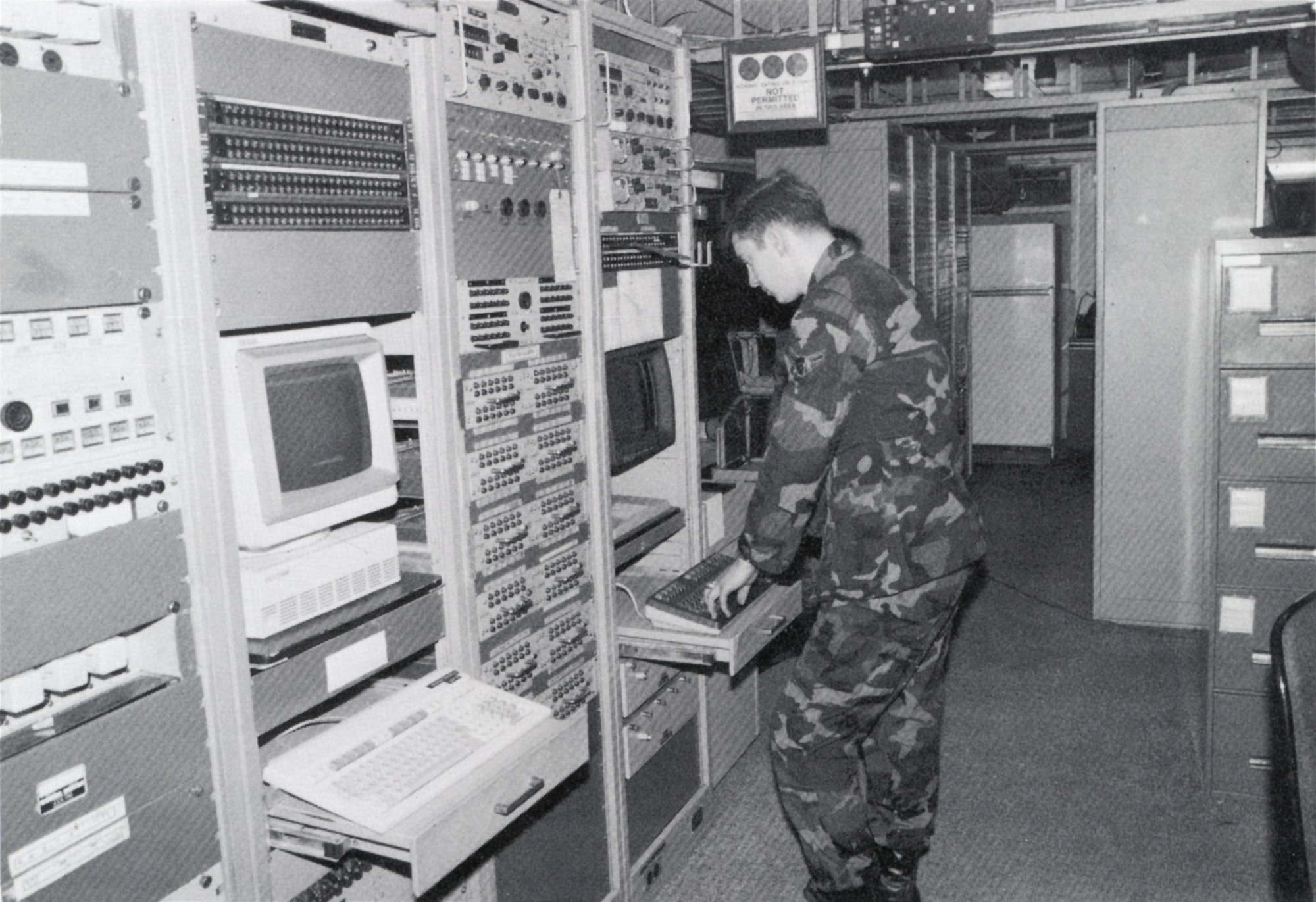 A1C Mark Williams checks the status of Digital European Backbone remote unmanned sites using transmission monitoring and control equipment, Europe.