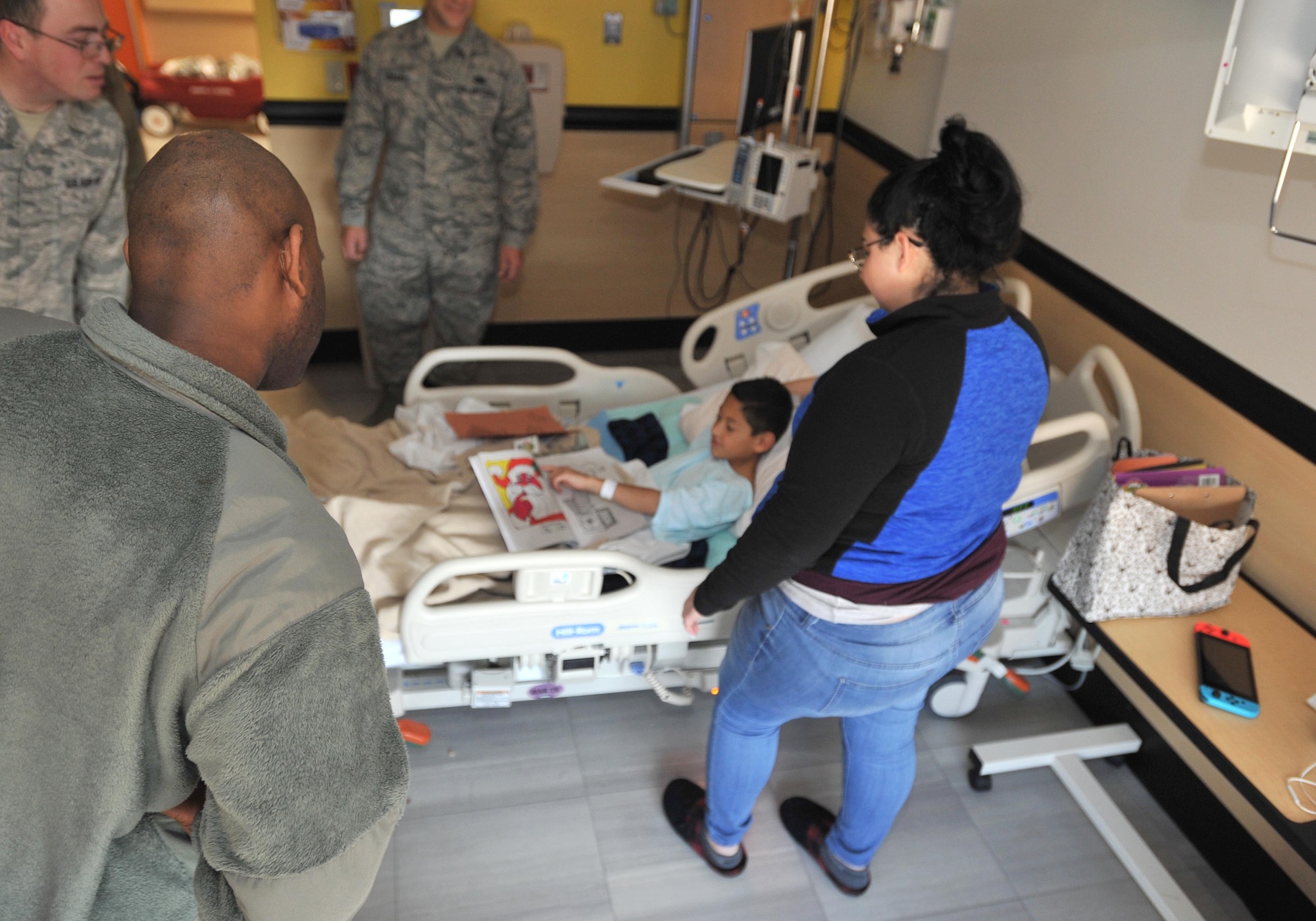 A child shows off a drawing of Santa Claus to Air Force members Dec. 18, 2018, at Wesley Children’s Hospital. The members were distributing toys to spread some holiday cheer to those who were staying in the hospital. (U.S. Air Force photo by Staff Sgt. David Bernal Del Agua)