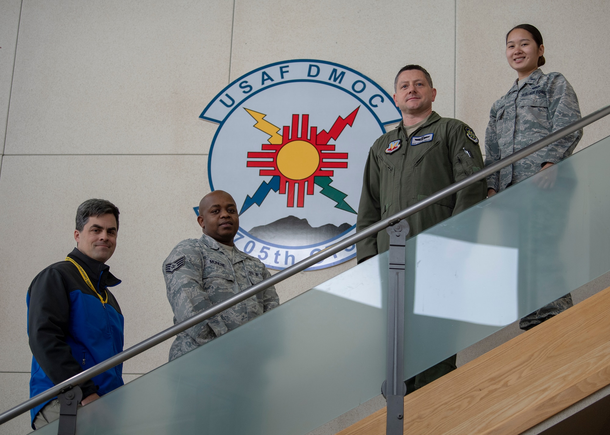 From left to right, Ray Renfrow, Science Application International Corporation modeling and simulation engineer; Staff Sgt. Anthony Munene, 705th Combat Training Squadron commander support staff NCO in charge; Master Sgt. Charles Phillips, 705th CTS superintendent; and 1st Lt. Arthittiya Mongkolsombat, 705th CTS executive officer pose for a photo at Kirtland Air Force Base, N.M., Dec. 11, 2018. These individuals each took part in saving the life of Maj. Myles Cheatum, 552nd Air Control Wing plans and programs deputy director, who went into cardiac arrest while TDY at Kirtland AFB. (U.S. Air Force photo by Staff Sgt. J.D. Strong II)