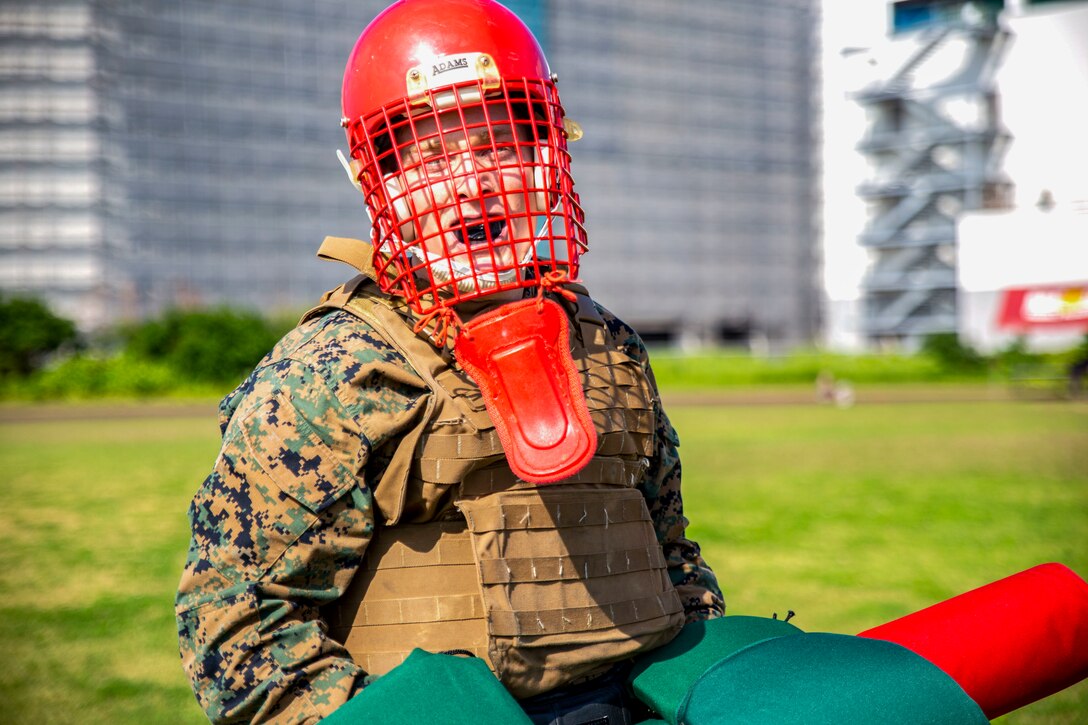 Sgt. Justin Boetger prepares to take part in a pugil stick bout at the fourth annual Reindeer Games on Camp Kinser, Okinawa, Japan, Dec. 18, 2018. The Reindeer Games are a holiday-themed, family event held to boost morale and camaraderie among the Marines, Sailors and families of Combat Logistics Regiment 37, 3rd Marine Logistics Group. Boetger is a food service specialist with Headquarters Company, CLR-37, 3rd MLG and a native of Bakersfield, California. (U.S. Marine Corps photo by Cpl. Joshua Pinkney)