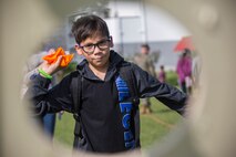 Xavier N. Celis prepares to throw a beanbag during the fourth annual Reindeer Games on Camp Kinser, Okinawa, Japan, Dec. 18, 2018. The Reindeer Games are a holiday-themed, family event held to boost morale and camaraderie among the Marines, Sailors and families of Combat Logistics Regiment 37, 3rd Marine Logistics Group. Xavier’s father, 1st Sgt. Joshua B. Celis, is a native of Houston, Texas, and is the company first sergeant of Headquarters Company, CLR-37, 3rd MLG. (U.S. Marine Corps photo by Lance Cpl. Terry Wong)