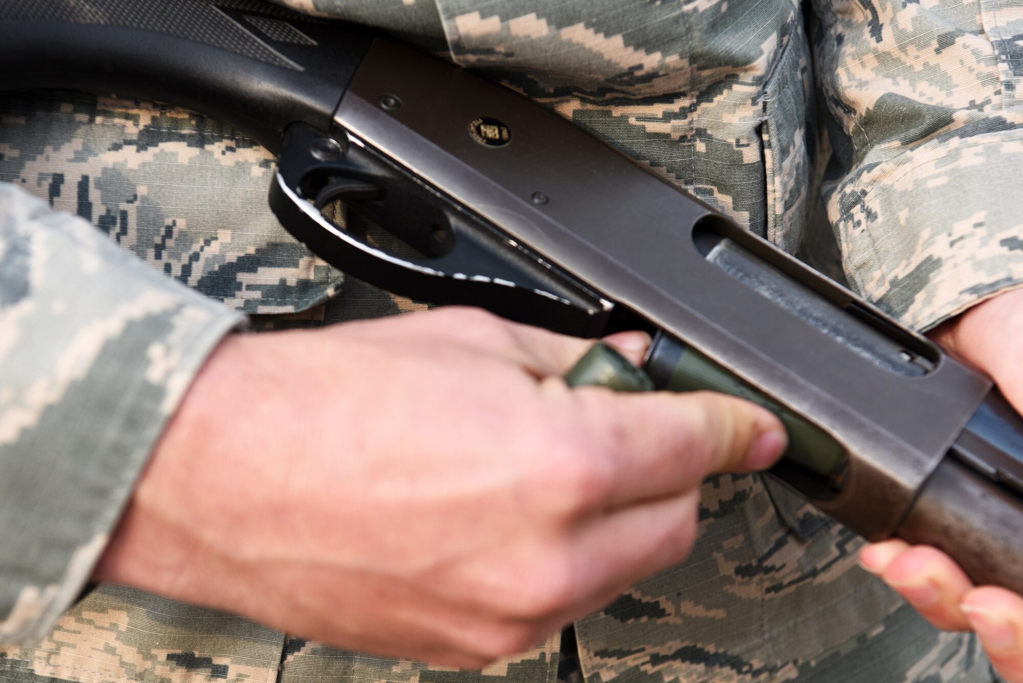 U.S. Air Force Tech. Sgt. Erick Hall, 8th Operations Support Squadron aircrew flight equipment lead trainer, loads a shotgun near the runway at Kunsan Air Base, Republic of Korea, Dec. 13, 2018. Hall is a member of the Bird and Wildlife Aircraft Strike Hazard group, which helps protect aircraft during takeoff by ensuring the runway is clear of animals. (U.S. Air Force photo by Staff Sgt. Joshua Edwards)