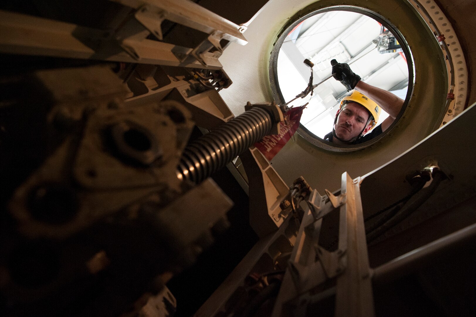 Senior Airman Zachari Dragan, 8th Expeditionary Aircraft Maintenance Squadron (EAMS) crew chief, helps remove a C-17 Globemaster III’s pitch trim actuator Dec. 16, 2018, at Al Udeid Air Base, Qatar. This is the first time a maintenance procedure like this has been done in U.S. Air Forces Central Command’s area of responsibility. Due to safety concerns, Airmen from the 8th EAMS and 379th Expeditionary Civil Engineer Squadron combined capabilities to ensure the aircraft could be repaired prior to returning to home station. (U.S. Air Force photo by Tech. Sgt. Christopher Hubenthal)