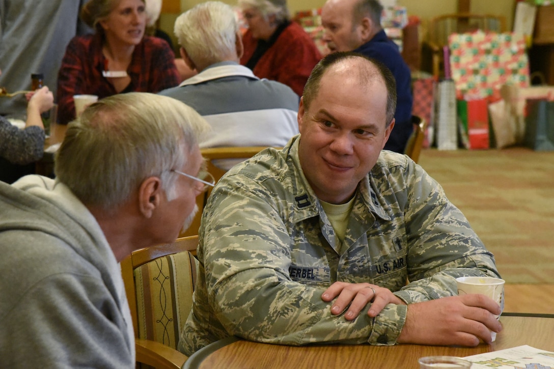 U.S. Air Force Capt. Dellas Herbel, a chaplain at the 119th Wing, visits with a veteran at the North Dakota Veterans Home, Lisbon, N.D., Dec. 11, 2018.