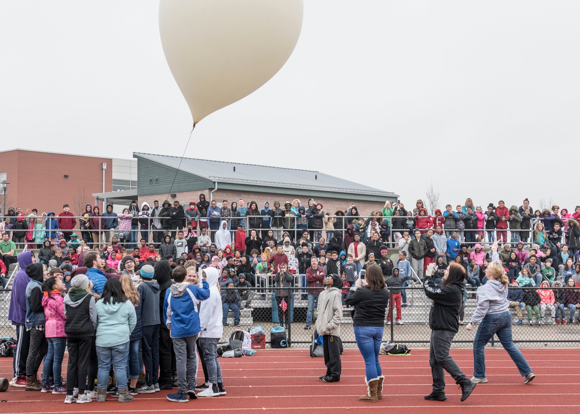 Approximately 650 students watch as eighth graders execute their year-long science, technology, engineering, and mathematics project made possible through an Air Force STEM grant, Nov. 30, 2018, Belleville, Illinois. Three schools, Emge Junior High School, Smithton Middle School and Belle Valley School, worked together to launch a balloon that carried a high-altitude computer, which analyzed data ranging from altitude and coordinates traveled to temperature and pressure. The students found the popped balloon 140 miles away in Mount Carmel, Illinois.