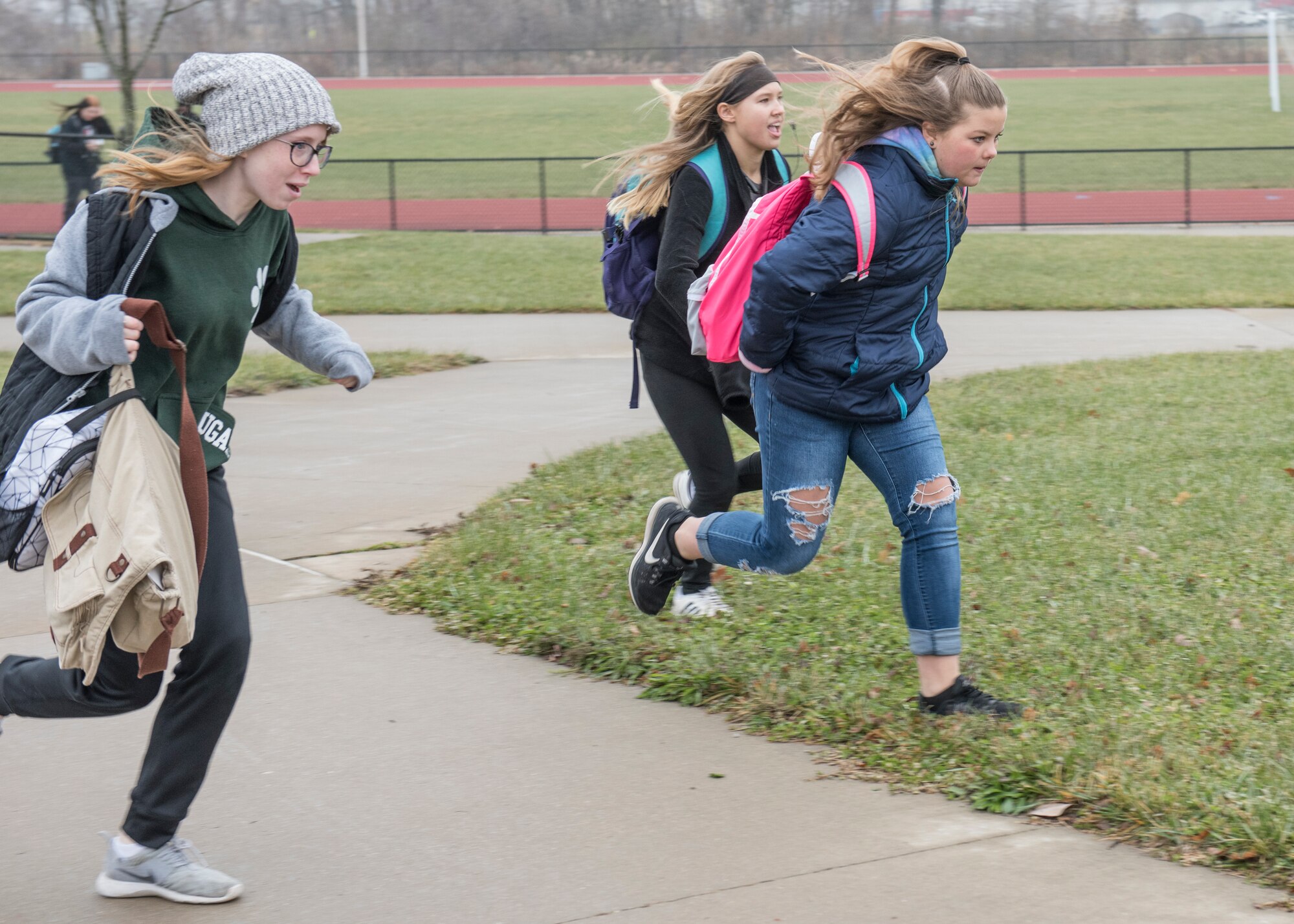 Abby Carlton, Savannah Hoffman, and Allyssa Owen, Smithton Middle School eighth graders, rush to the school bus to retrieve the recently launched high-altitude computer after their year-long science, technology, engineering, and mathematics project made possible through an Air Force STEM grant, Nov. 30, 2018, Belleville, Illinois. Three schools, Emge Junior High School, Smithton Middle School and Belle Valley School, worked together to launch a balloon that carried a high-altitude computer, which analyzed data ranging from altitude and coordinates traveled to temperature and pressure. The students found the popped balloon 140 miles away in Mount Carmel, Illinois.