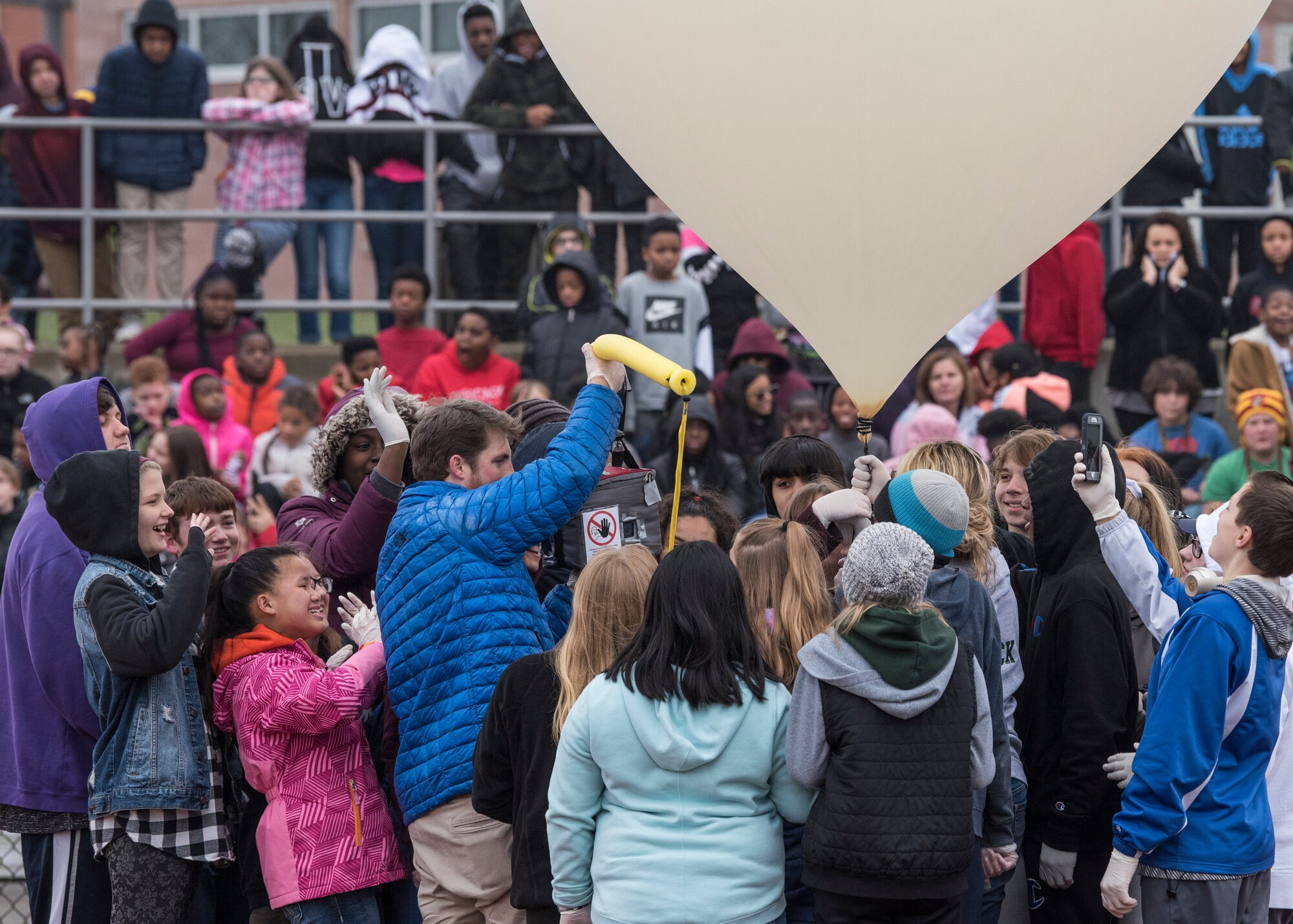 Approximately 650 students watch as eighth graders execute their year-long science, technology, engineering, and mathematics project made possible through an Air Force STEM grant, Nov. 30, 2018, Belleville, Illinois. Three schools, Emge Junior High School, Smithton Middle School and Belle Valley School, worked together to launch a balloon that carried a high-altitude computer, which analyzed data ranging from altitude and coordinates traveled to temperature and pressure. The students found the popped balloon 140 miles away in Mount Carmel, Illinois.