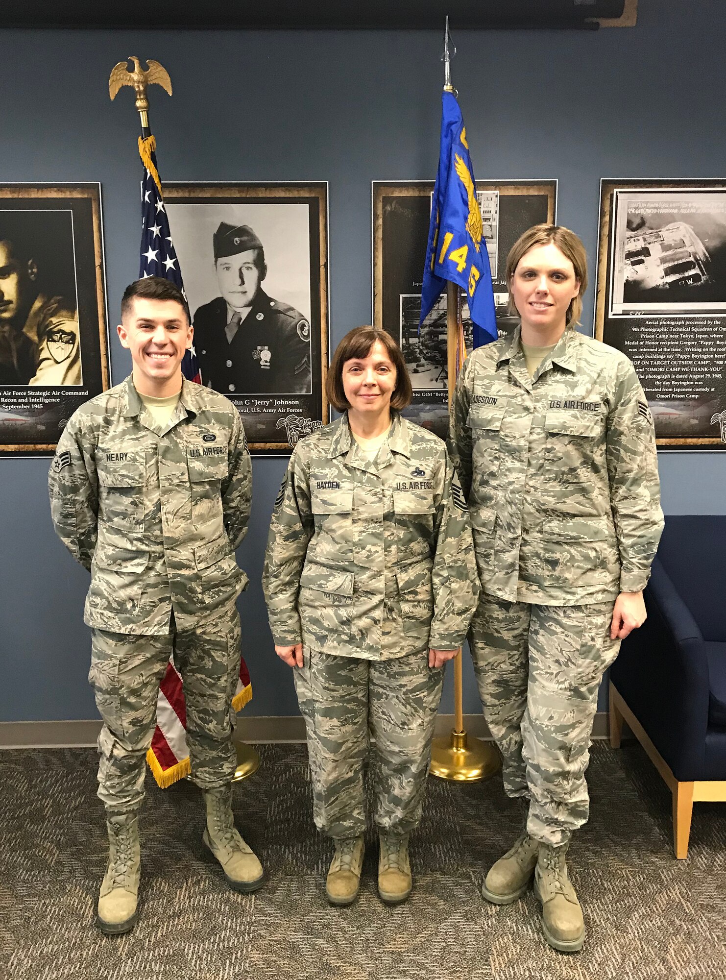 (left) Senior Airman Alexander Neery, 14 Intelligence Squadron intelligence analyst, and (right) Senior Airman Amanda Logsdon, 14 IS intelligence analyst, were presented the Diamond Sharp Award by (middle) Master Sgt. Angela Hayden, 14 IS first sergeant, during the December 16, 2018 unit training assembly.