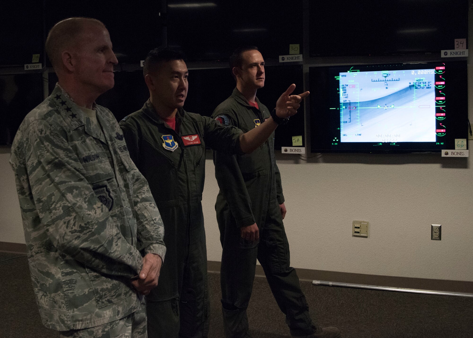 Air Force Vice Chief of Staff Gen. Stephen Wilson receives a briefing from Capt. Thanh Doan (middle), 29th Attack Squadron MQ-9 Reaper pilot, and Staff Sgt. John Eddington (right), 29th ATKS sensor operator, during his tour of Holloman Air Force Base, N.M., November 30. Wilson was briefed on the 29th ATKS’s current training operations, and shown an operational demonstration in an MQ-9 cockpit. (U.S. Air Force photo by Staff Sgt. BreeAnn Sachs)