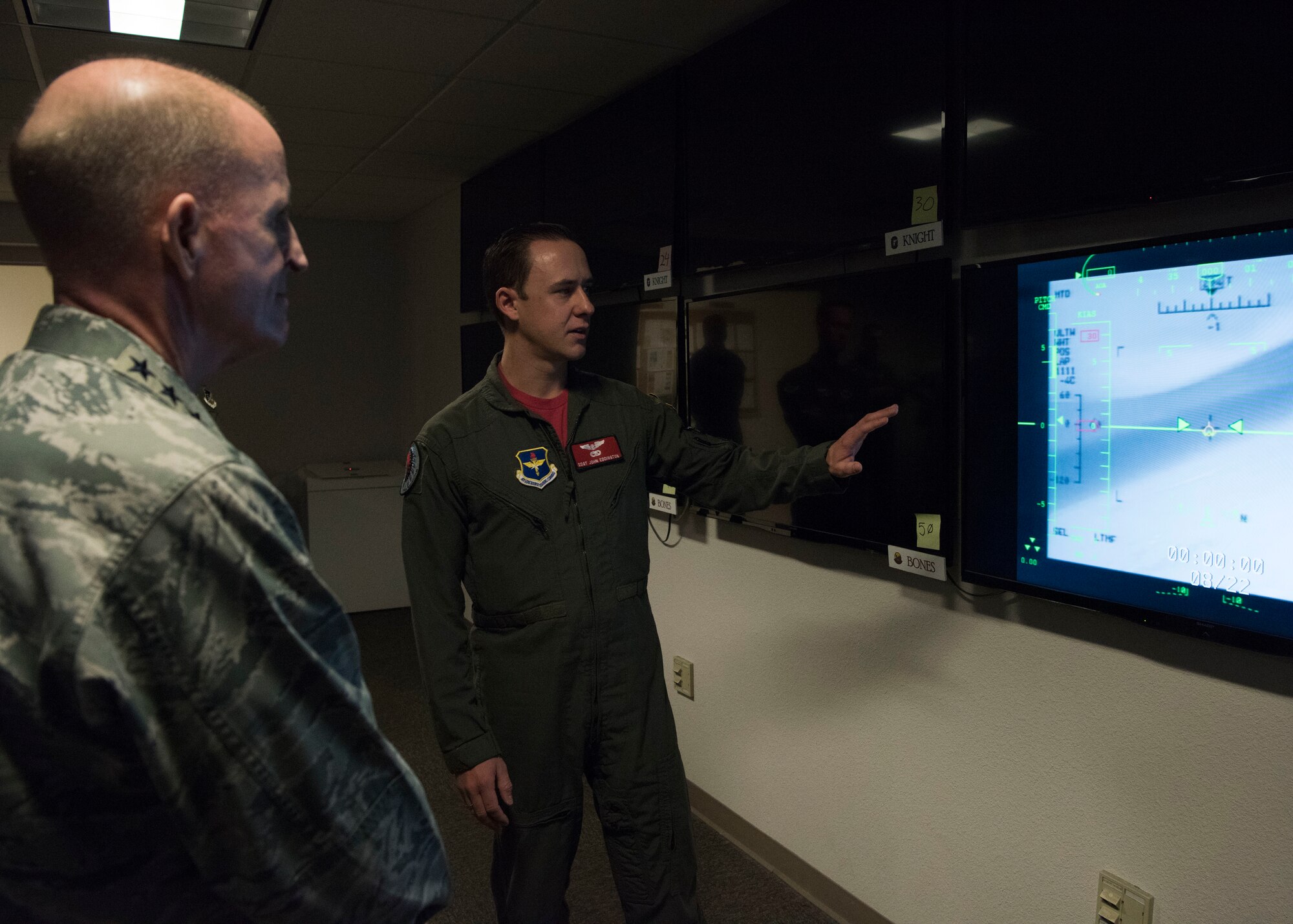 Air Force Vice Chief of Staff Gen. Stephen Wilson receives a briefing from Staff Sgt. John Eddington, 29th Attack Squadron sensor operator, during his tour of Holloman Air Force Base, N.M., November 30. Eddington explained the 29th ATKS’s current training operations and showed Wilson a simulated MQ-9 Reaper live feed. (U.S. Air Force photo by Staff Sgt. BreeAnn Sachs)