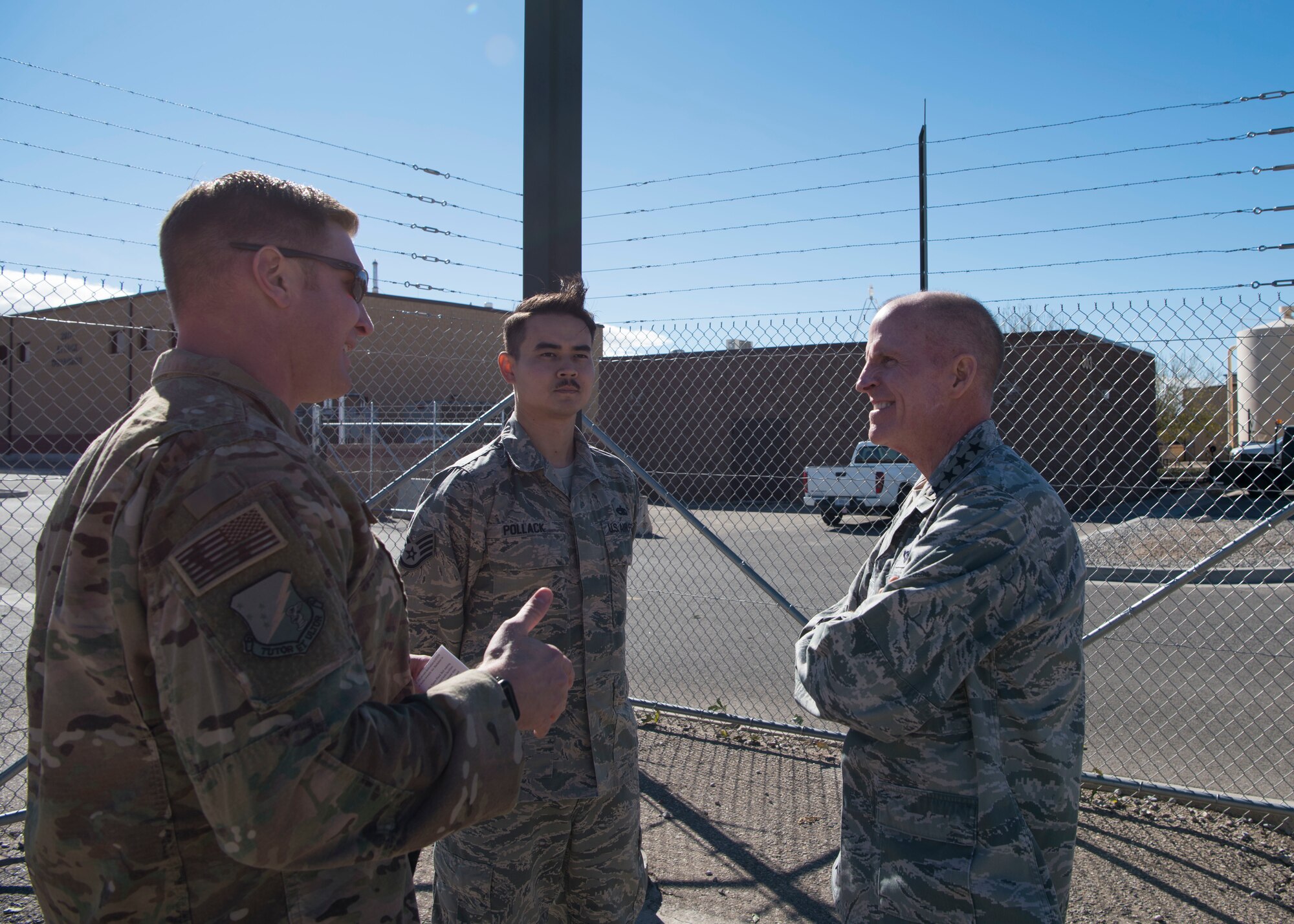 Air Force Vice Chief of Staff Gen. Stephen Wilson speaks to Maj. Brett Flickinger (left), 49th Component Maintenance Squadron commander and Staff Sgt. Jason Pollack (middle), 49th CMS Precision Measurement Equipment Laboratory technician, during a tour of Holloman Air Force Base, N.M., November 30. Wilson coined Pollack for his outstanding work during recent operations. (U.S. Air Force photo by Staff Sgt. BreeAnn Sachs)