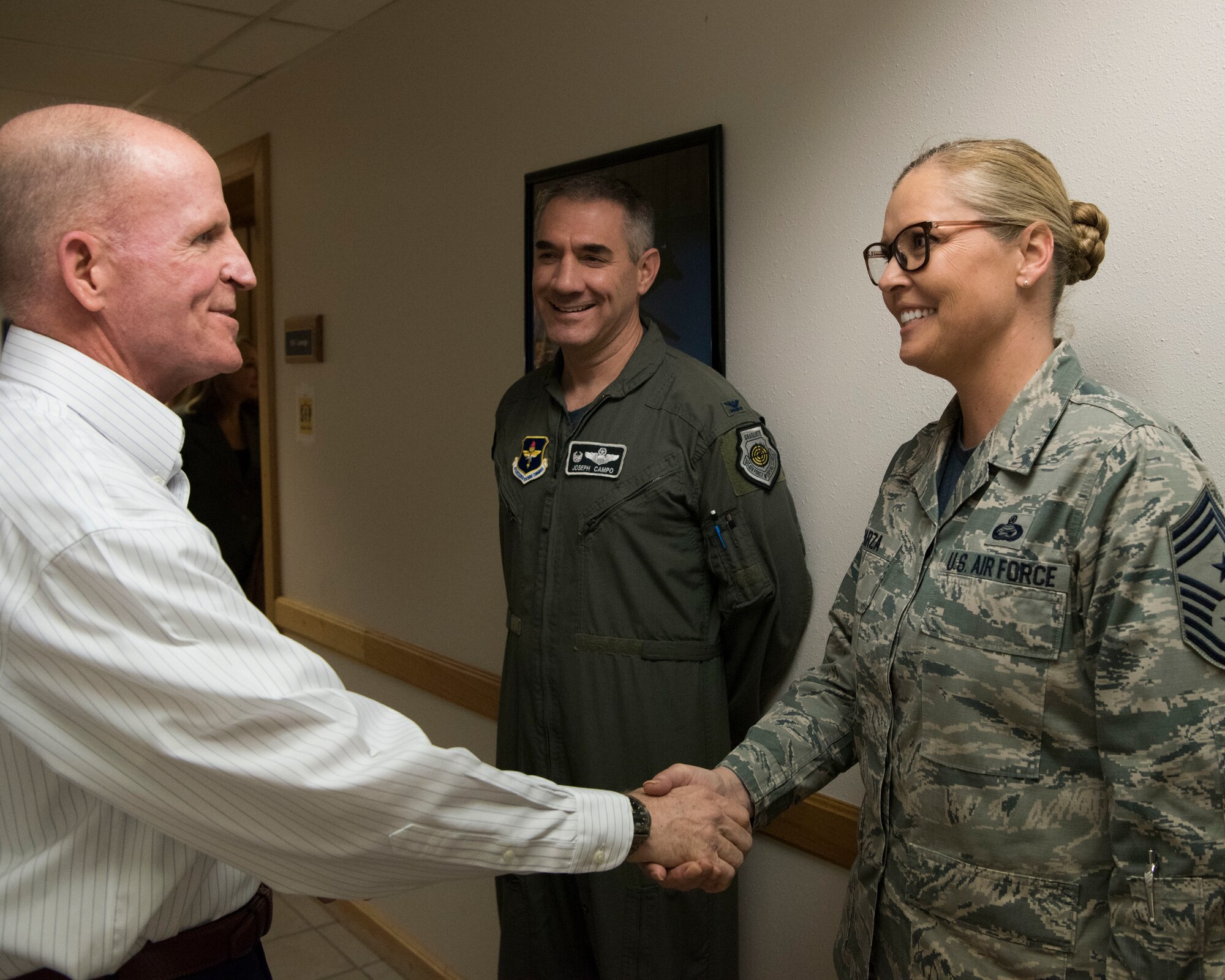 Air Force Vice Chief of Staff Gen. Stephen Wilson coins Chief Master Sgt. Sarah Esparza, 49th Wing command chief, November 30 on Holloman Air Force Base, N.M. Wilson received a tour of Holloman after officiating a retirement ceremony for a former enlisted aide. (U.S. Air Force photo by Staff Sgt. BreeAnn Sachs)