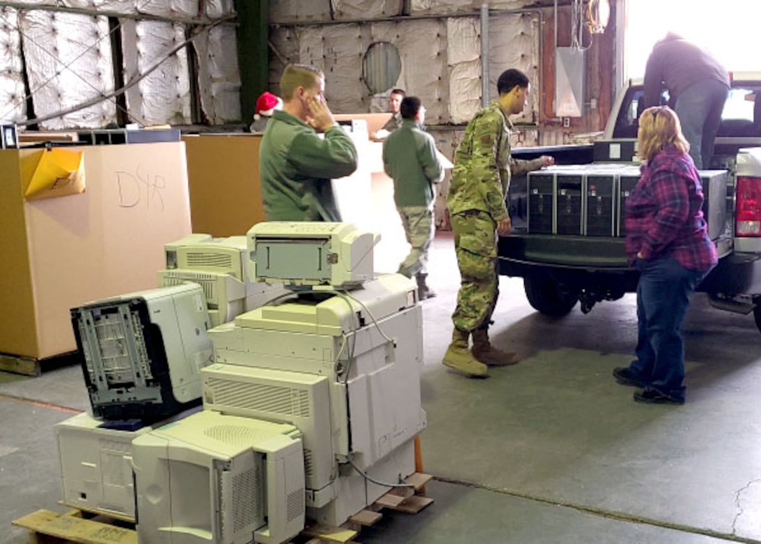 Margaret Jones, an agency rep from the DLA Disposition Services site at Nellis, stands next to the pickup truck’s tailgate as Air force service members unload excess computes for possible use in the Computers For Learning program and recycling.