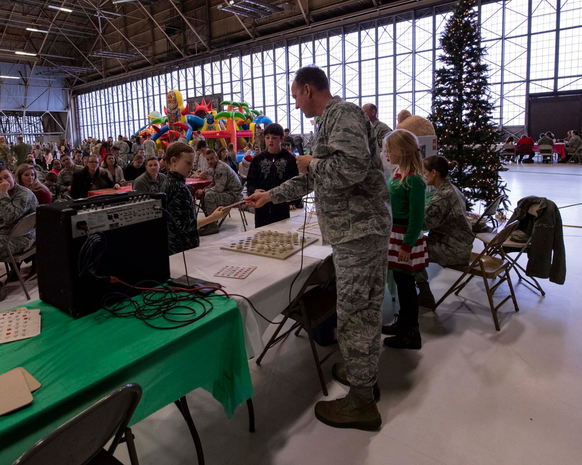 Col. Johan Deutscher, commander of the 141st Air Refueling Wing, checks bingo cards during the wing’s annual Winter Fest Dec. 1, 2018 at Fairchild Air Force Base, Wash. More than 900 Airmen assigned to the 141st are welcome to take part in the festivities along with their families to celebrate the holiday season. (U.S. Air National Guard photo by Staff Sgt. Rose M. Lust/Released)