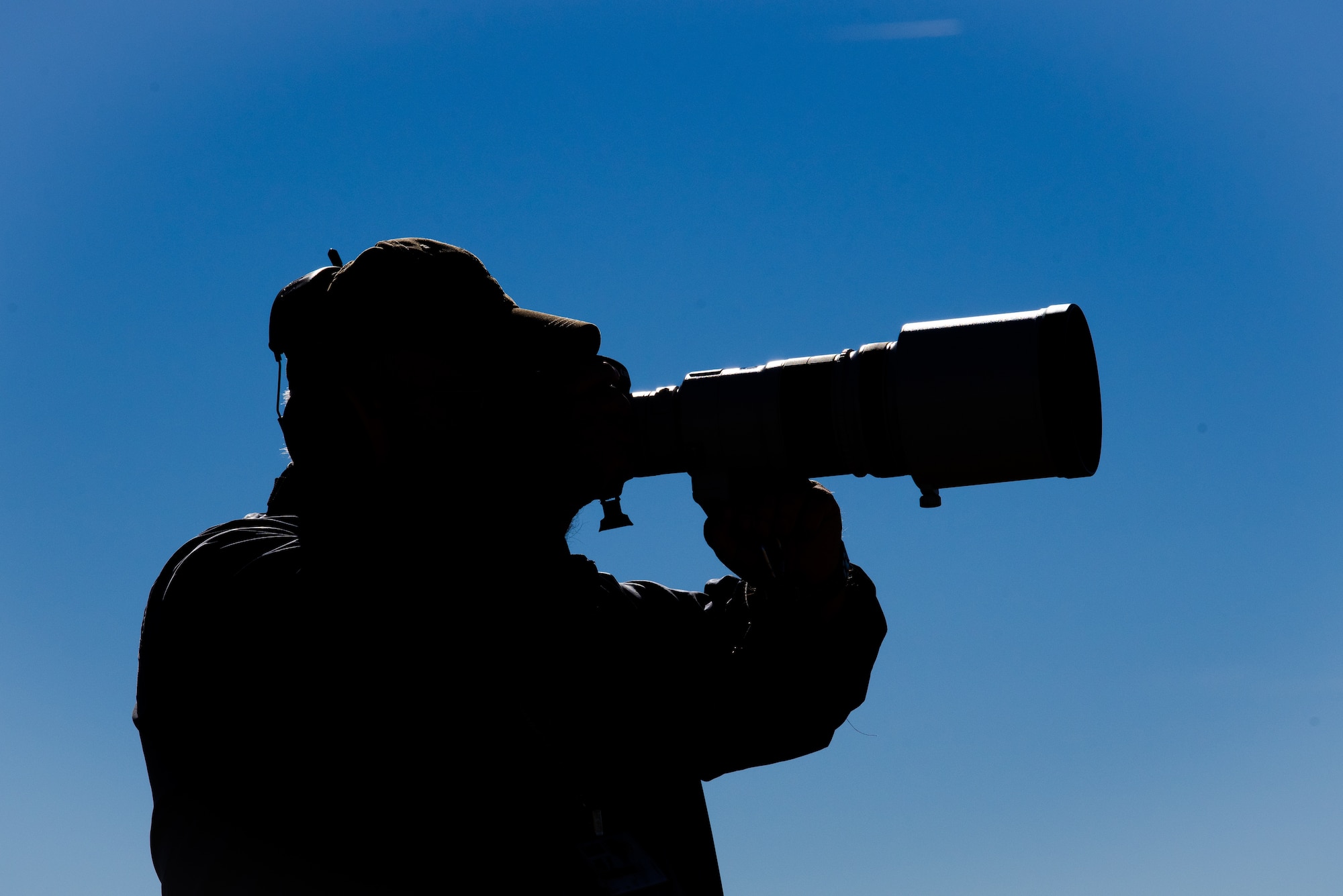 Harvey Brugger, 56th Operations Support Squadron air traffic controller, follows an aircraft taxing down the runway with his camera, Dec. 13, 2018, at Luke Air Force Base, Ariz.