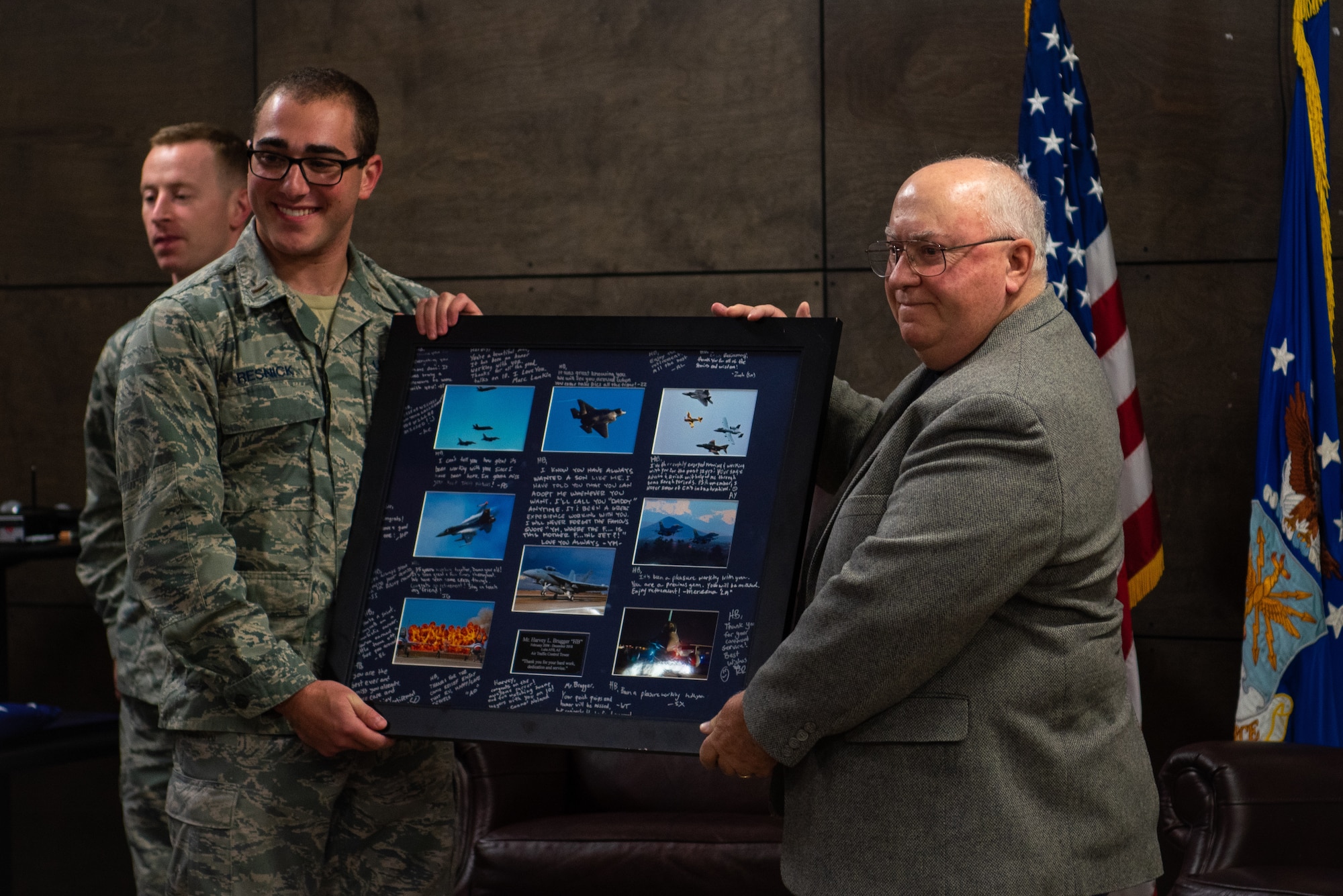 Harvey Brugger, 56th Operations Support Squadron air traffic controller, accepts a retirement gift during his retirement ceremony, Dec 17, 2018, at Luke Air Force Base, Ariz.