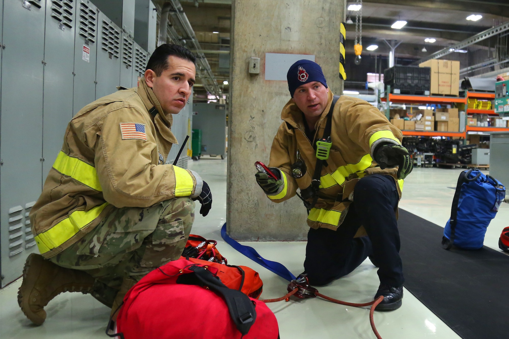 Firefighters anchor safety ropes for confined space rescue training at the Western Air Defense Sector Nov. 11, 2018, on Joint Base Lewis-McChord, Washington. Once the simulated patient was secured to a spinal board the firefighters used the ropes as a safety measure when lifting the patient out of the confined space. (U.S. Air National Guard photo by Master Sgt. Tim Chacon)