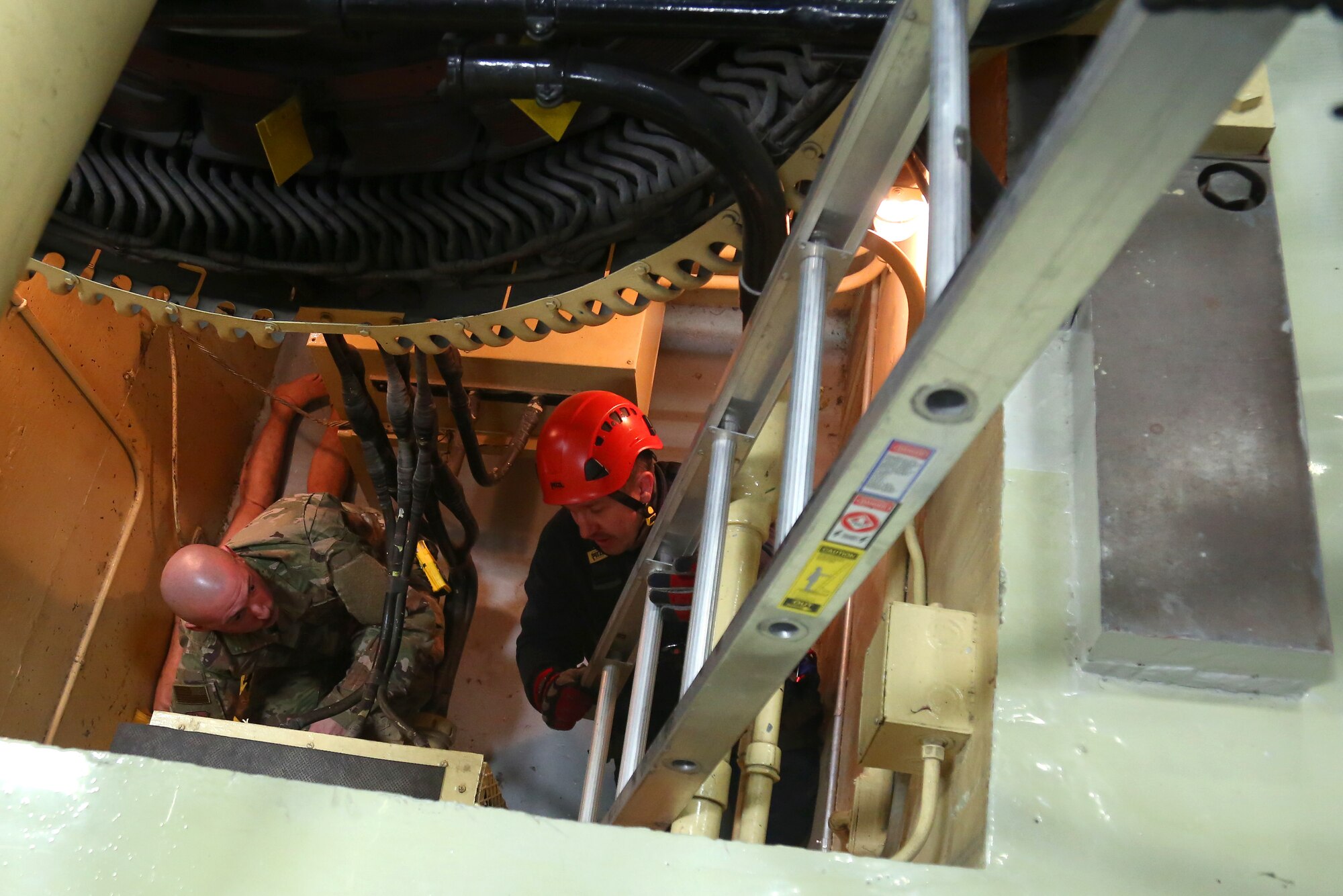 Master Sgt. Trever Bohling, Western Air Defense Sector, tends to a simulated patient in confined space rescue Nov. 11, 2018, on Joint Base Lewis-McChord, Wash. Bohling administered first aid to the simulated patient as the emergency personnel arrive on scene. (U.S. Air National Guard photo by Master Sgt. Tim Chacon)
