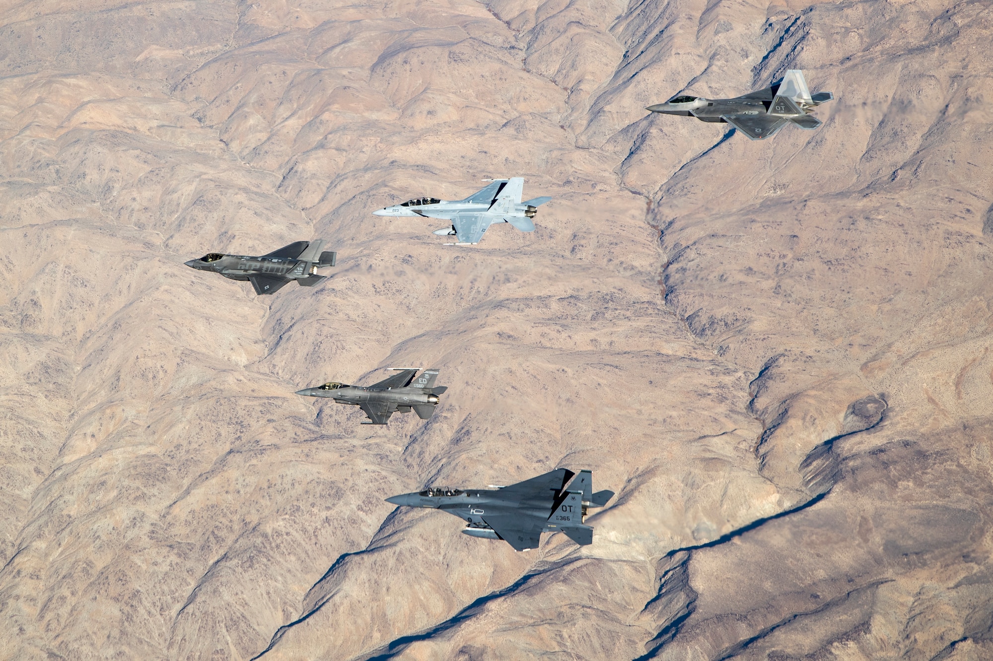 An F-35 and F-16 from Edwards Air Force Base are joined by an F-15E and F-22 from the 422nd Test and Evaluation Squadron out of Nellis Air Force Base, Nevada, along with a Navy F-18 from Air Test and Evaluation Squadron 31 out of Naval Air Weapons Station China Lake, California, Dec. 31. (U.S. Air Force photo by Ethan Wagner)