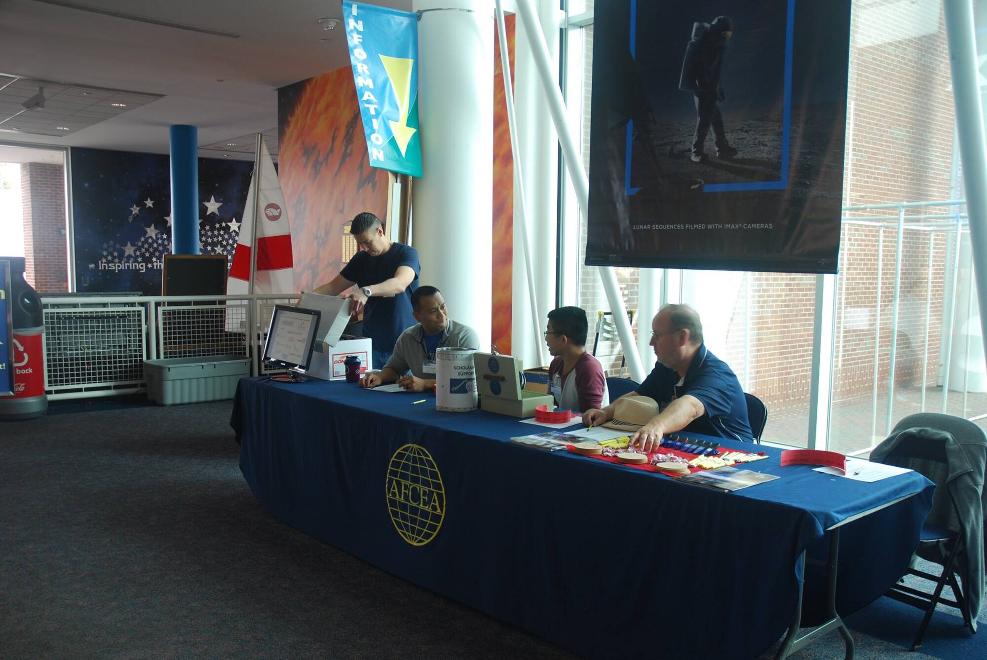 A team of Armed Forces Communications and Electronics Association volunteers set up an information desk at an Annual Science Technology Engineering and Mathematics event at the Virginia Air & Space Center in Hampton, Virginia, Nov. 3, 2018. The event was held as a family-focused outreach opportunity for children and adults of all ages. The Air Force uses these types of events as part of a recruiting effort to spark interest in STEM among children, high school students, and college students. (U.S. Air Force courtesy photo)