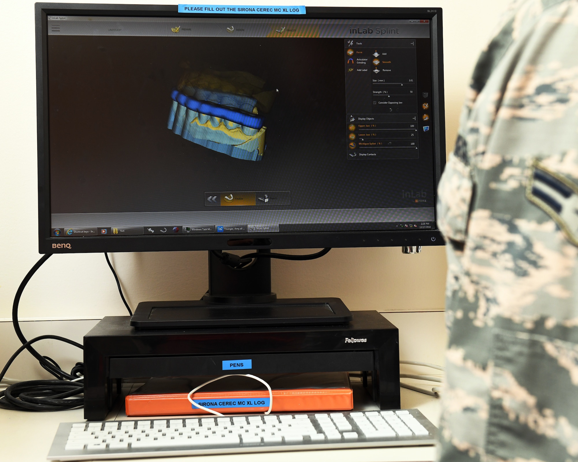 A Formlabs Form2 printer operated by Airmen with the 60th Dental Squadron prints a dental guard at Travis Air Force Base, California, Dec. 17, 2018. The printer was purchased with Squadron Innovation Funds provided by the U.S. Air Force Chief of Staff, Gen. David Goldfein. The Form2 printer is a stereolithographic 3D multiple resin printer designed for use in dentistry. The innovative printer reduces the manning hours required to produce dental prosthetics by up to 85 percent, cutting hands-on production time from three hours to 30 minutes. (U.S. Air Force photo by Louis Briscese)