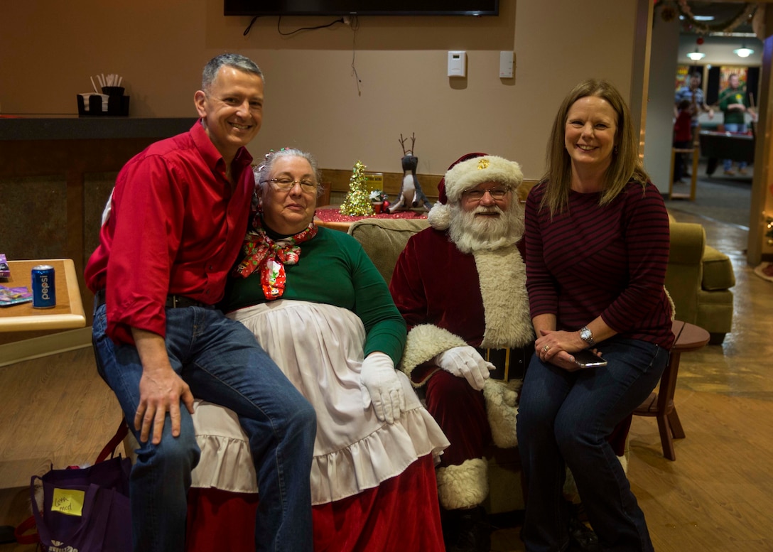 U.S. Marine Corps Col. William C. Gray, commanding officer of 6th Marine Corps District, far left, and his wife Debbie Gray, far right, pose for a photo with Mr. and Mrs. Clause, during the 6th MCD Holiday Dinner at Afterburners aboard Marine Corps Air Station Beaufort, South Carolina, Dec. 14, 2018. Vivian and Ray Otto are both natives of Mechanicsville, Virginia. (U.S. Marine Corps photo by Lance Cpl. Jack A. E. Rigsby)