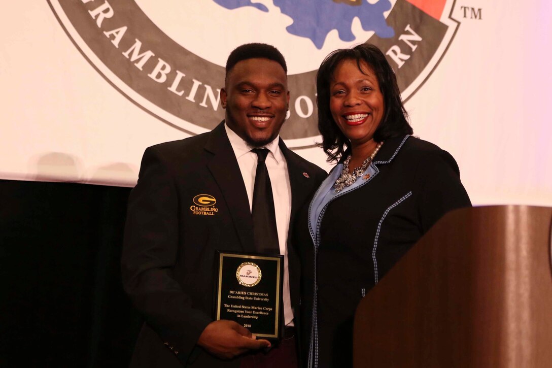 Judge Tamia Gordon, a former U.S. Marine, presents a United States Marine Corps Excellence in Leadership award to De'Arius Christmas, a Grambling State University linebacker, at the Leadership Awards Coaches Luncheon in New Orleans, Nov 23, 2018. 


“The unifying theme of my remarks was about 'Battles Won' -- analogizing battles won by the Marine Corps and battles won by the players on and off the football field,” said Gordon. 


Gordon currently serves as the associate chief administrative law judge for the Department of Health and Human Services, Office of Medicare Hearings and Appeals, at the New Orleans Field Office. (U.S. Marine Corps photo by Sgt. Nathaniel Cray/Released)