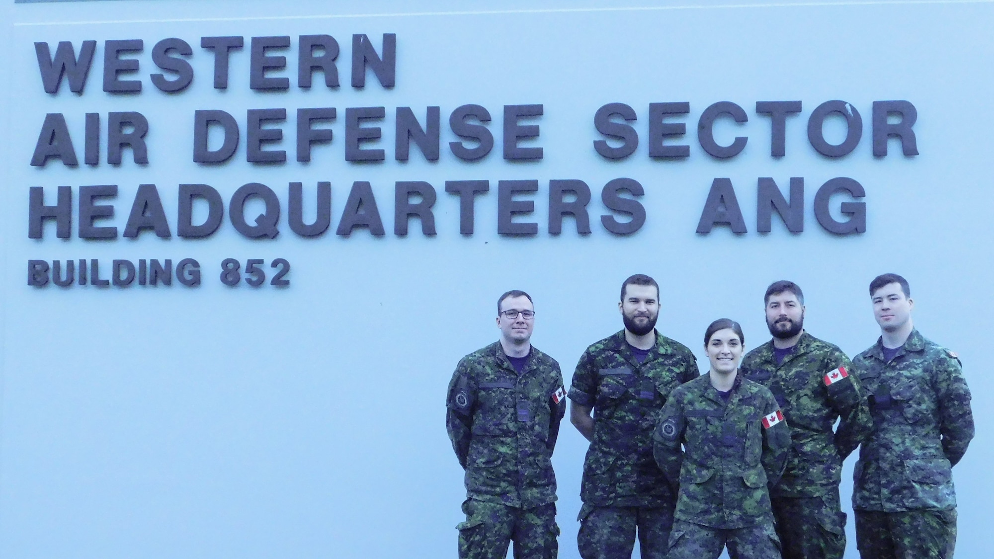 The Western Air Defense Sector hosted air battle managers of the Royal Canadian Air Force for a five week period this fall in order to complete their qualification training.  Members of 12 Radar Squadron, 3 Wing, pose in front of the Western Air Defense Sector Nov. 15, 2018 on Joint Base Lewis-McChord, Washington.  From left to right, Lt. James McGuigan, Capt. Matt Smith, 2nd Lt. Sophie Guerin, Capt. Kevin Vincent and Lt. Anthony Dufour. (Courtesy photo)
