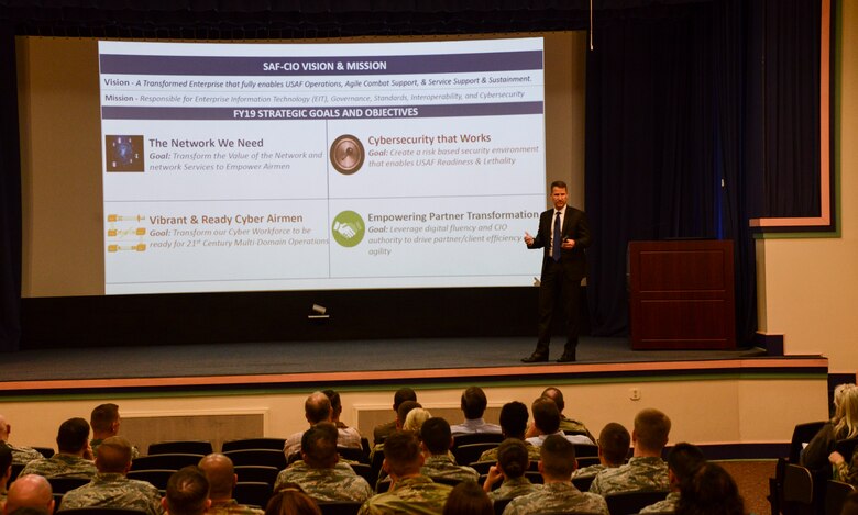 One person speaking to a crowd of people