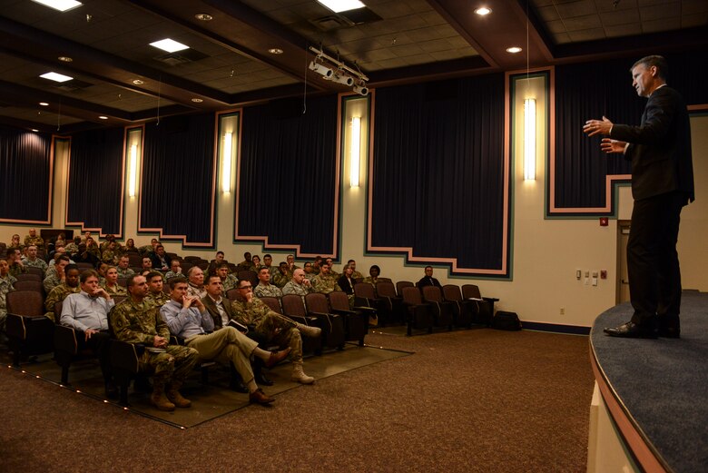 One person speaking to a crowd of people