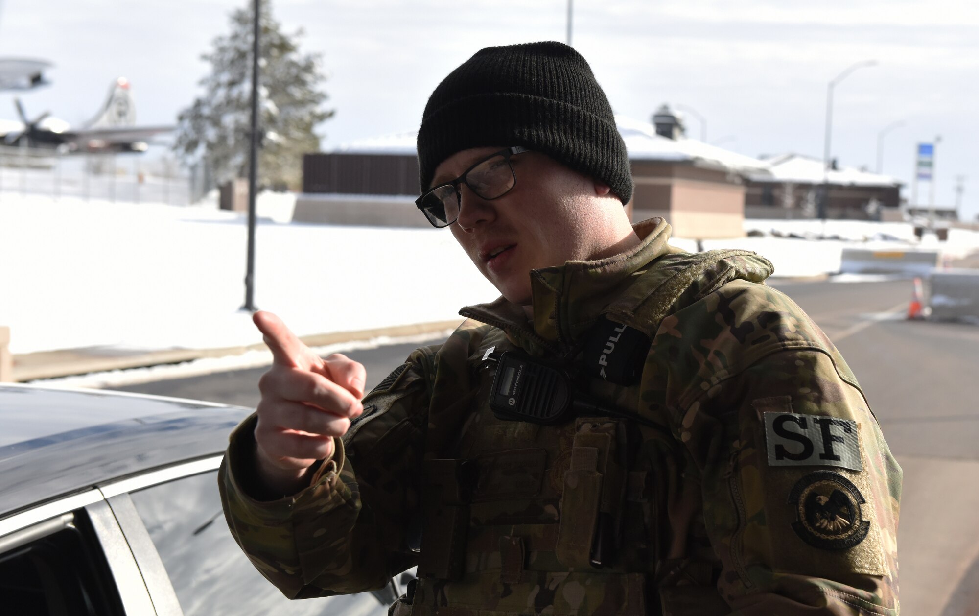 Senior Airman Taylor Tschida, a 28th Security Forces Squadron alarm monitor, gives directions to a person entering Ellsworth Air Force Base, S.D., through Liberty Gate on Dec. 4, 2018. Each person that comes through the gate gets checked for proper authorization, correct seatbelt wear and that their vehicle has registration on the plates. (U.S. Air Force photo by 2nd Lt. Joshua Sinclair)