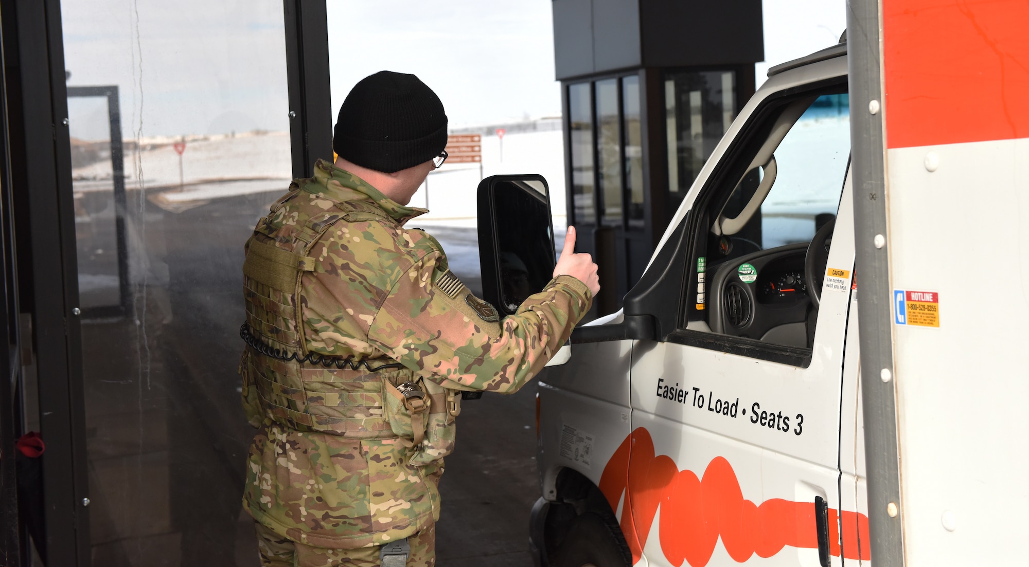 Senior Airman Taylor Tschida, a 28th Security Forces Squadron alarm monitor, lets a mover know that he’s good to go through Liberty Gate and on to base housing at Ellsworth Air Force Base, S.D., Dec. 4, 2018. Each person that comes through the gate gets checked for proper authorization, correct seatbelt wear and that their vehicle has registration on the plates. (U.S. Air Force photo by 2nd Lt. Joshua Sinclair)