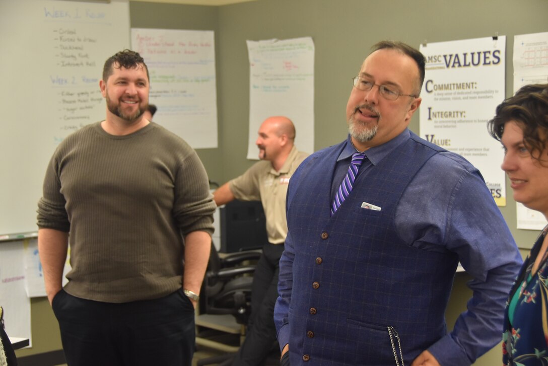 EMH 0410    John Kutzman (center), a writer and instructor at the Army Management Staff College, spends a candid moment with his students, Fort Leavenworth, Kansas, December 14.