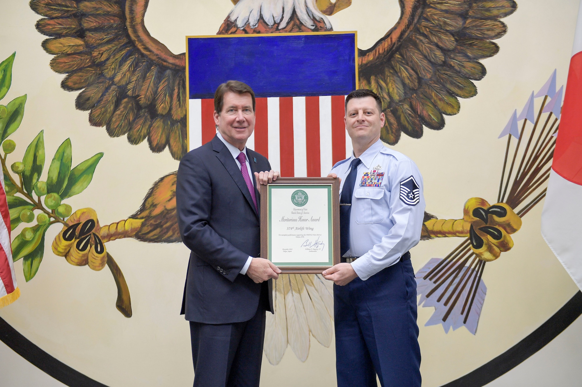 U.S. Ambassador to Japan William F. “Bill” Hagerty IV, and U.S. Air Force Master Sgt. Johnathan Marker, 374th Logistics Readiness Squadron fuels operation section chief, pose for a photo