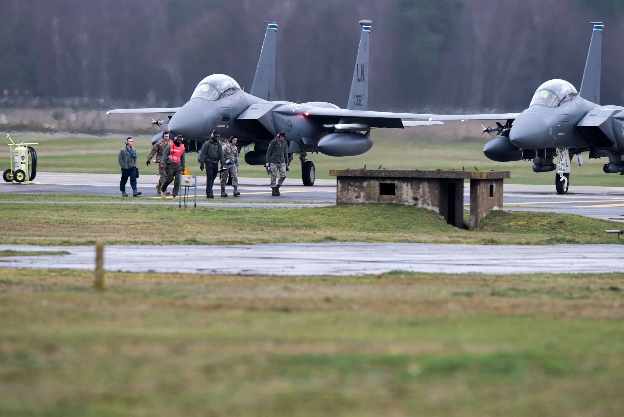 Maintainers assigned to the 48th Maintenance Group prepare F-15E Strike Eagles assigned to the 492nd Fighter Squadron for a sortie at Royal Air Force Lakenheath, England, Dec. 18, 2018. The 48th Maintenance Group is responsible for all organizational and intermediate level maintenance for F-15C, F-15D, F-15E Strike Eagle aircraft, engines, munitions and support equipment used to accomplish U.S. Air Forces in Europe and Africa, U.S. European command and NATO commitments and taskings. (U.S. Air Force photo by Senior Airman Malcolm Mayfield)