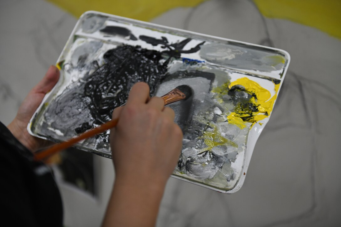 Tech. Sgt. Maralene Scarpino, an aircraft maintenance specialist assigned to the 910th Maintenance Squadron, paints a mural in the 910th Maintenance Group's heritage room at Youngstown Reserve Station, Dec. 17, 2018.